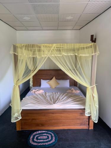 a bedroom with a bed with a canopy at Happy Living Weligama in Weligama