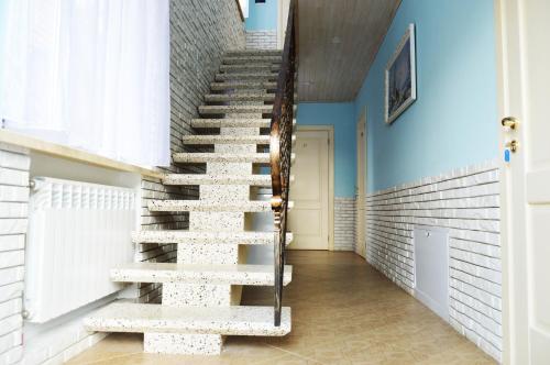 a staircase in a hallway with blue walls at Agio Hotel in Kolochava