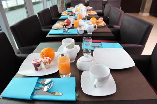 a long table with plates of food on it at Residhome Nantes Berges De La Loire in Nantes