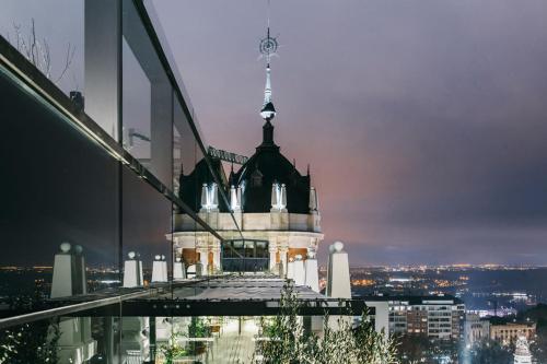a building with a clock tower on top of a building at Dear Hotel Madrid in Madrid