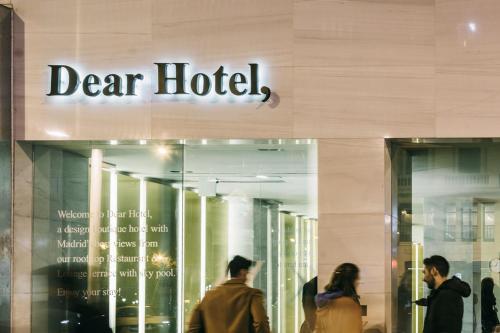people walking in front of a dear hotel building at Dear Hotel Madrid in Madrid