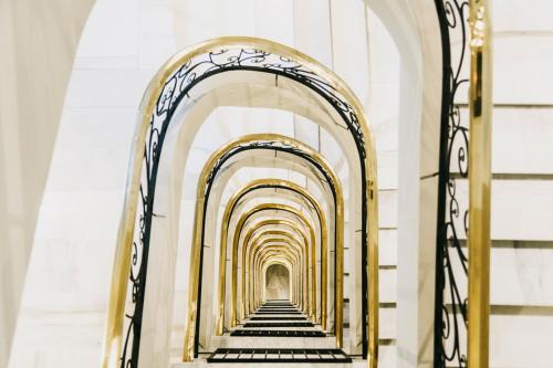 a hallway of an archway in a building at Dear Hotel Madrid in Madrid