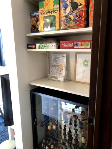 a book shelf filled with lots of toys at Casa上熊本2 in Kumamoto