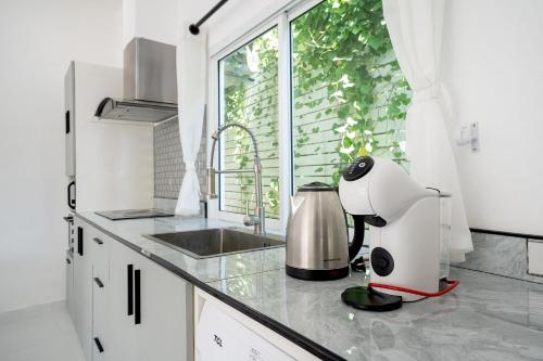 a kitchen with a mixer on a counter with a window at 哦先生的海景别墅 Aoyon Beach in Phuket Town