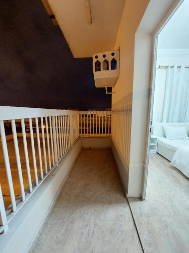 a room with a balcony with a stair railing at Salalah Peace House in Salalah