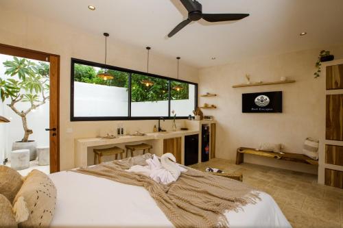 a bedroom with a large bed and a sink at Bali Escapes- Studio And 1 Bedroom Villa in Uluwatu