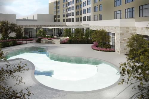 a swimming pool in the courtyard of a building at The Westin Dallas Southlake in Southlake