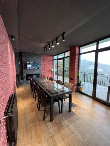 a dining room with a table and a view of the water at Villa Deluxe Kvariati in Kvariati