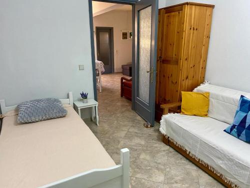 a bedroom with two beds and a door to a room at Farm Villa in Áyios Pávlos