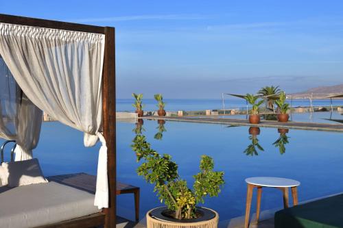 a room with a bed and a view of the water at Hilton Taghazout Bay Beach Resort & Spa in Taghazout