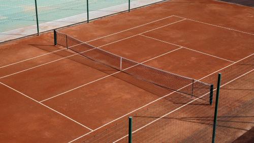 a tennis court with a net on top of it at Hilton Taghazout Bay Beach Resort & Spa in Taghazout