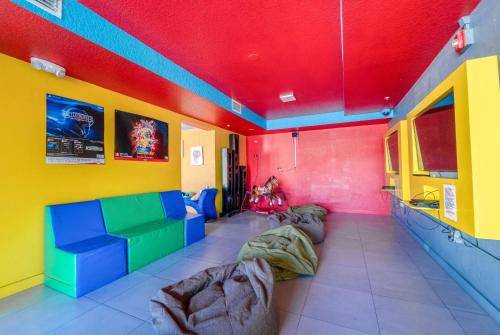 a living room with colorful walls and couches at Ramada by Wyndham Flamingo Water Park in Kissimmee