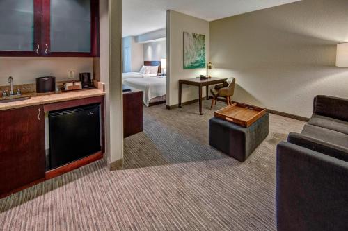 a hotel room with a couch and a bed at SpringHill Suites by Marriott Naples in Naples