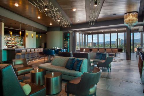 a lobby of a hotel with chairs and a bar at The Westin Chattanooga in Chattanooga