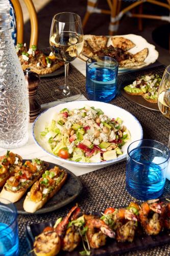 a table with plates of food and glasses of wine at Residence Inn by Marriott Chicago Downtown Magnificent Mile in Chicago