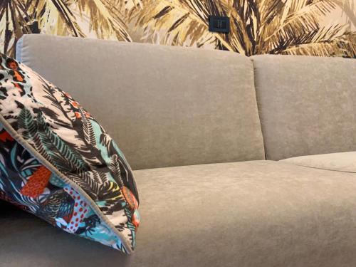 a couch with a colorful pillow on it at Costa Rica Bibione Aparthotel in Bibione
