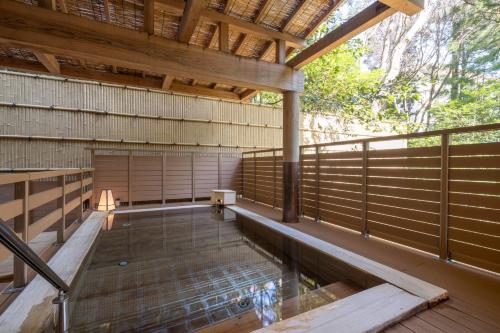 a house with a pool in the middle of a deck at Mizunoto Reopening on April 1, 2025 in Hakone
