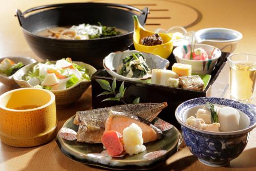 a table topped with bowls of different types of food at Mizunoto Reopening on April 1, 2025 in Hakone