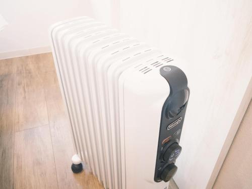 a white radiator is next to a wall at グランディオーソ中野富士見町 in Tokyo