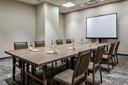a conference room with a large table and a white screen at The Westin Galleria Dallas in Dallas