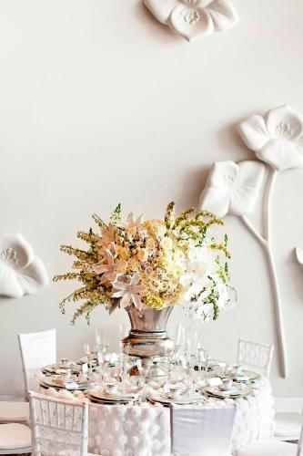 a table with a vase with flowers on it at The Westin Galleria Dallas in Dallas