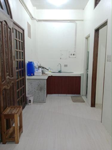 an empty kitchen with a sink and a table at WJV Inn Baltan Extension in Puerto Princesa City