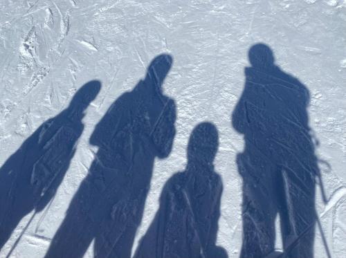 Un groupe d'ombres de gens debout dans la neige dans l'établissement Appartement Bourg Saint Maurice Proche funiculaire - 2 étoiles 4 cristaux paradiski, à Bourg-Saint-Maurice