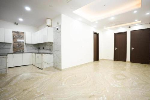 an empty room with white walls and a marble floor at Hotel Diamond Stay 10 Mints Walking From Nizamuddin Railway Station in New Delhi