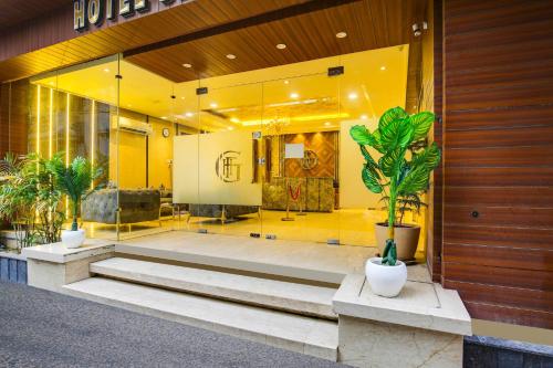 a lobby of a building with stairs and plants at Townhouse Grand Fortune in Amritsar