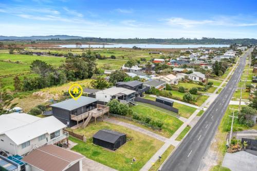 an aerial view of a small town with a road at Family Holiday at the Beach! in Pukehina