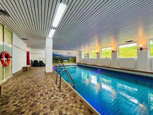 a pool in a hotel room with a swimming pool at Hirschzauber A9 Montana Haus in Oberstdorf