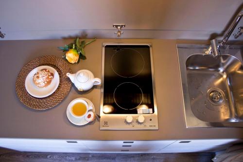 a microwave with a cup of coffee and a plate of food at Hotel Dolomiti in Malcesine