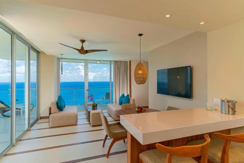 a living room with a view of the ocean at The Westin Cozumel in Cozumel
