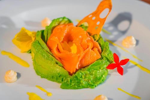 a cake shaped like a flower on a white plate at The Westin Cozumel in Cozumel