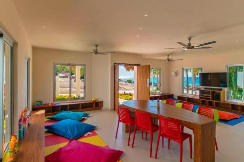 a dining room with a table and colorful pillows on the floor at The Westin Cozumel in Cozumel