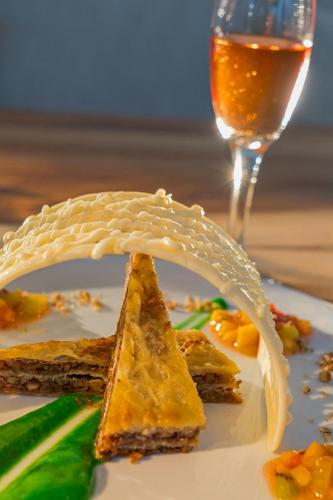 a plate with a piece of food and a glass of wine at The Westin Cozumel in Cozumel