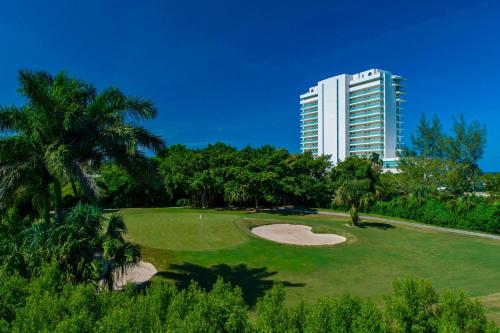 a golf course in front of a tall building at The Westin Cozumel in Cozumel