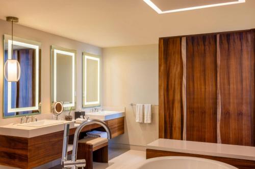 a bathroom with a sink and a mirror and a shower at The Westin Cozumel in Cozumel