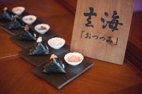 a table with four plates of food with rice at The Luigans Spa and Resort in Fukuoka