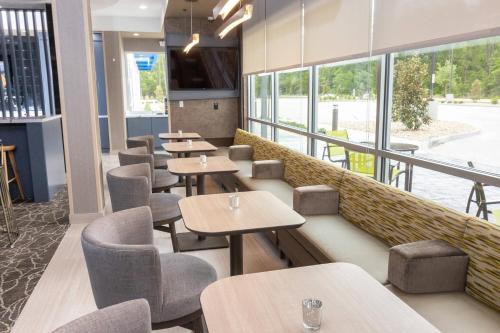a row of tables and chairs in a restaurant at SpringHill Suites by Marriott Slidell in Slidell