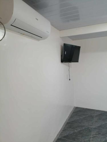 a tv on a wall in a room at FJM Transient in Tarlac
