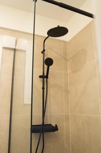 a shower with a glass door in a bathroom at Delightful 1st Floor Xanthippis Apartment in Strovolos