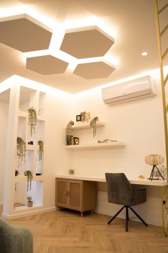 an office with white ceilings and a desk and chairs at Delightful 1st Floor Xanthippis Apartment in Strovolos