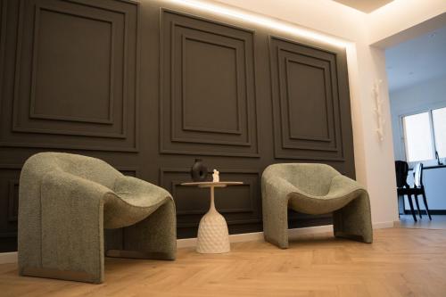 two chairs and a table in a living room at Delightful 1st Floor Xanthippis Apartment in Strovolos