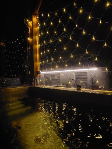 a pool of water with lights on a building at Hofpower`s Mountain Feeling in Hinterstoder