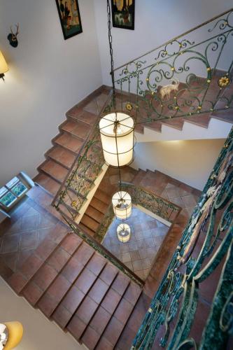 an overhead view of a staircase with a chandelier at Arabella Jagdhof Resort am Fuschlsee, a Tribute Portfolio Hotel in Hof bei Salzburg