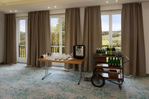 a room with a table with bottles of wine at Arabella Jagdhof Resort am Fuschlsee, a Tribute Portfolio Hotel in Hof bei Salzburg
