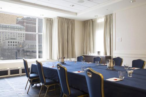 a conference room with blue tables and chairs and a large window at Hartford Marriott Downtown in Hartford
