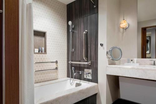 a bathroom with a tub and a sink at JW Marriott Austin in Austin