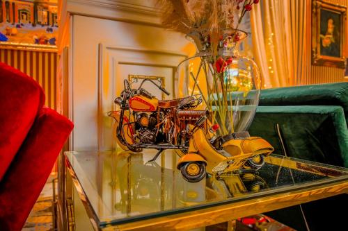 a vase with a scooter on a glass table at Envy Hotel in Durrës